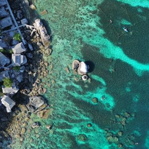 Explore the stunning coastline and clear waters of Ko Tao, Thailand from above.