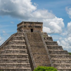 Stunning view of El Castillo pyramid at Chichén Itzá under a bright blue sky.